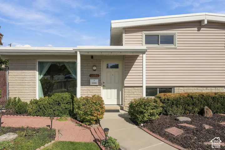 Multi-level exterior featuring horizontal siding and brick accents
