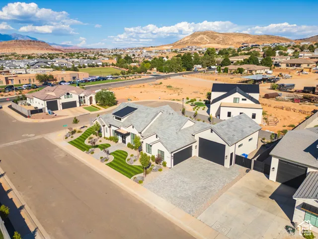 Modern-style exterior with a light-toned stucco finish and dark-toned roofing