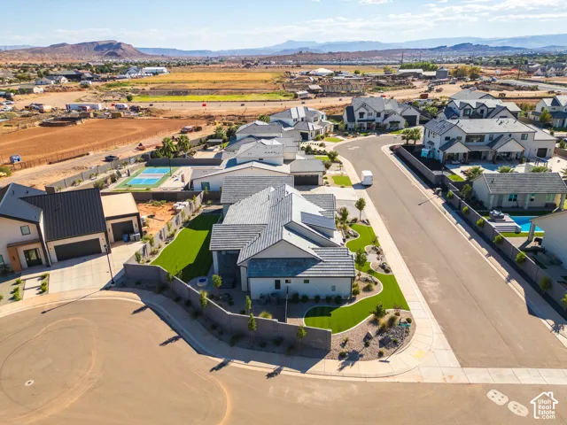 Stunning modern residence showcasing a clean-lined architectural design with dark metal roofing, crisp white exterior finishes, and manicured landscaping