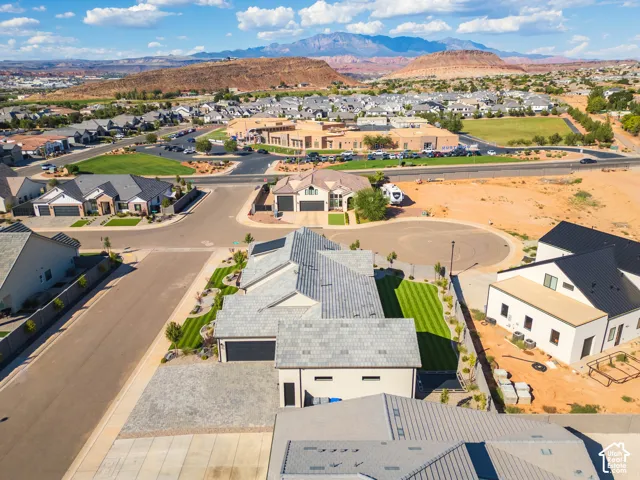 Newly constructed home featuring a modern architectural design with clean rooflines, metal accents, and a spacious driveway