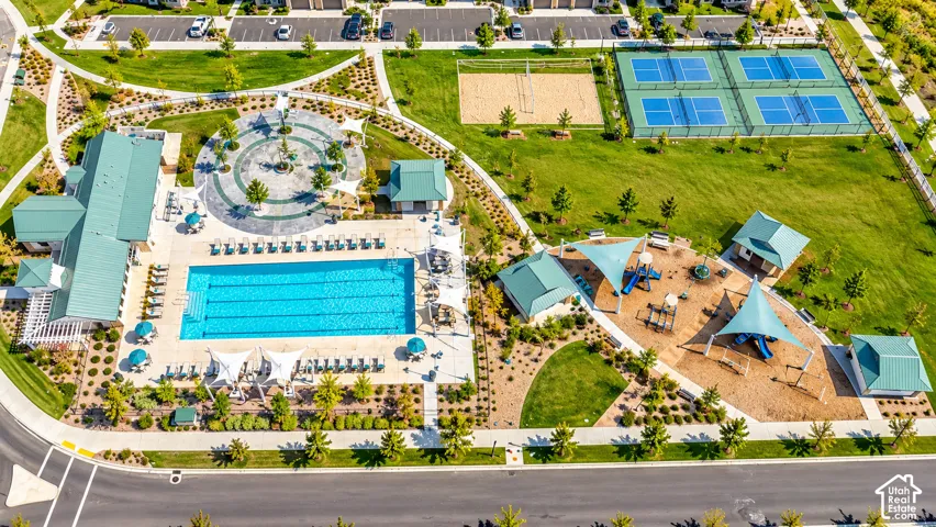 Community amenities featuring a large swimming pool, tennis courts, sand volleyball court, and a playground with shade structures