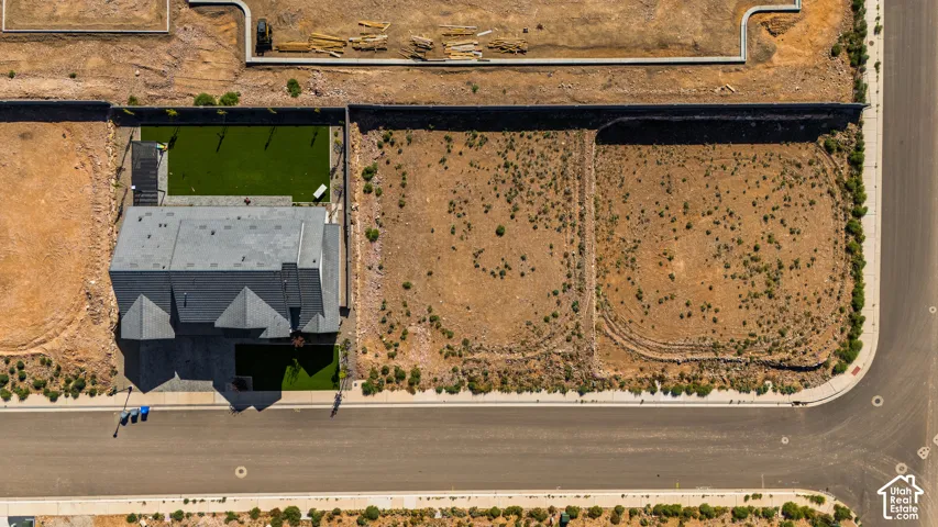 Modern residential property with a multi-gabled roof and a well-defined rear yard featuring artificial turf