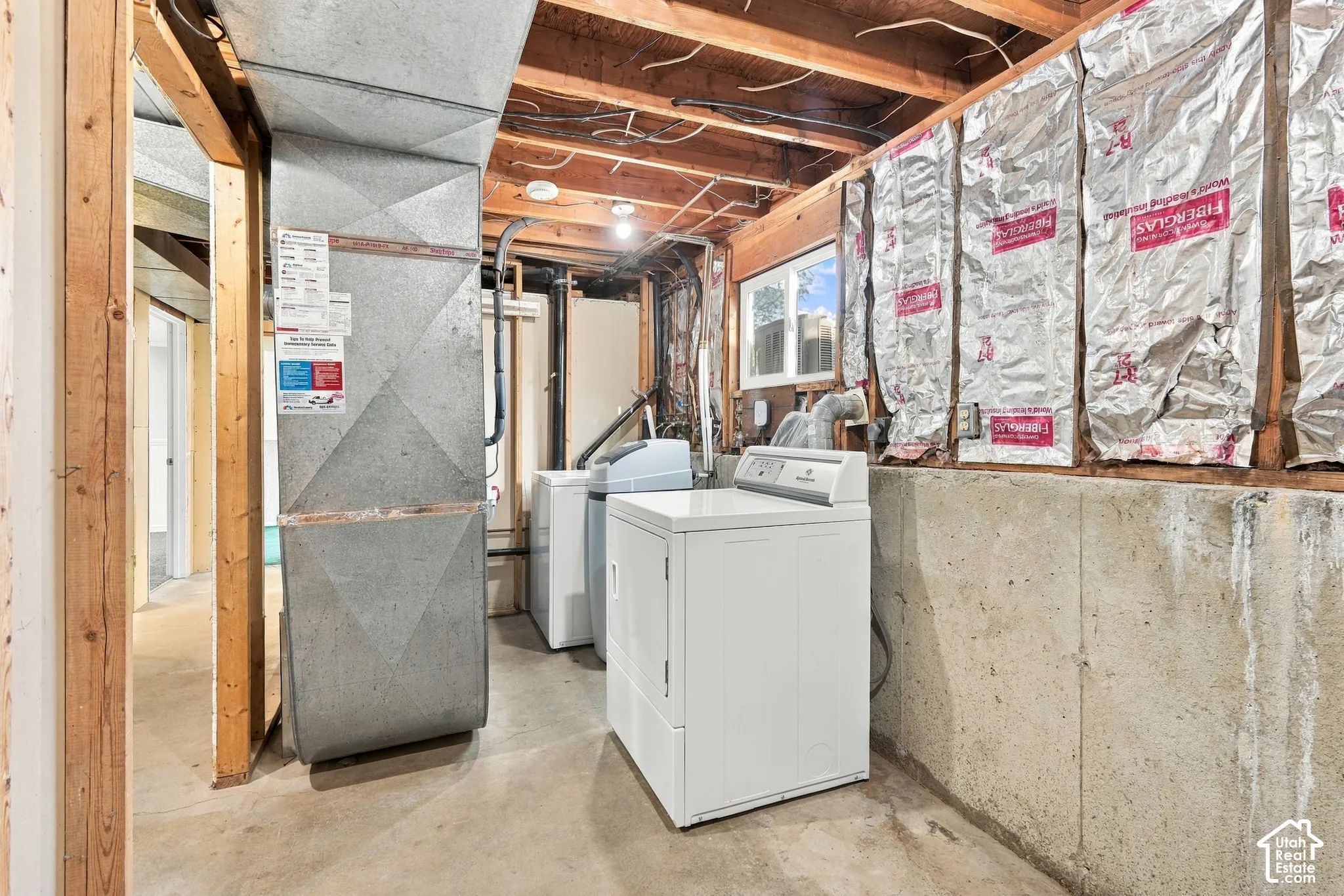 Unfinished basement with exposed ceiling joists and concrete flooring