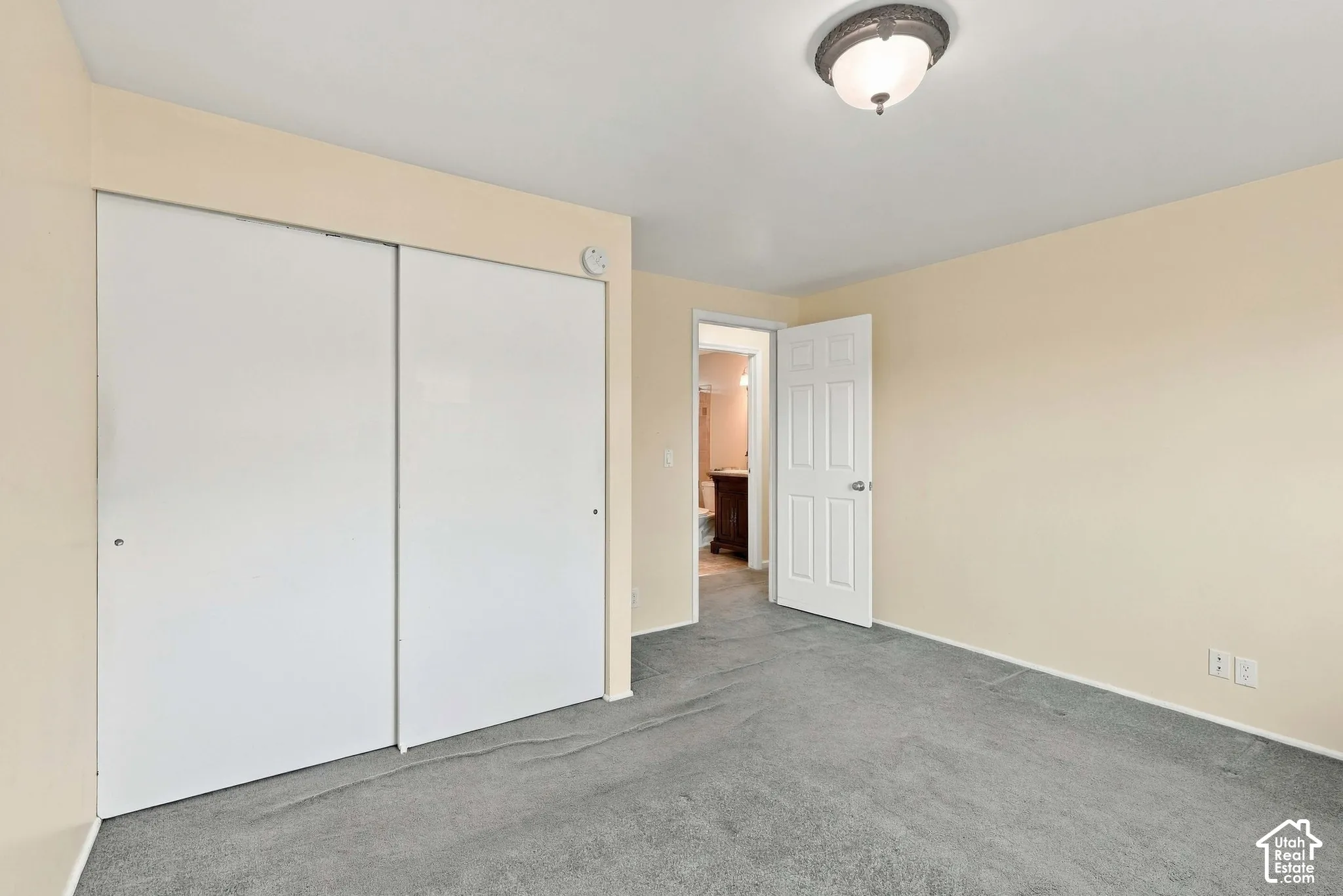 Neutral-toned walls complement the gray carpeting