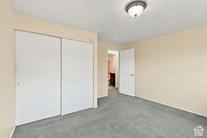 Neutral-toned walls complement the gray carpeting
