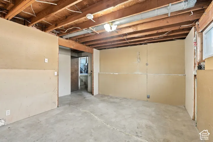 Exposed wood ceiling beams and concrete flooring