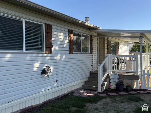 White siding exterior with brown decorative shutters