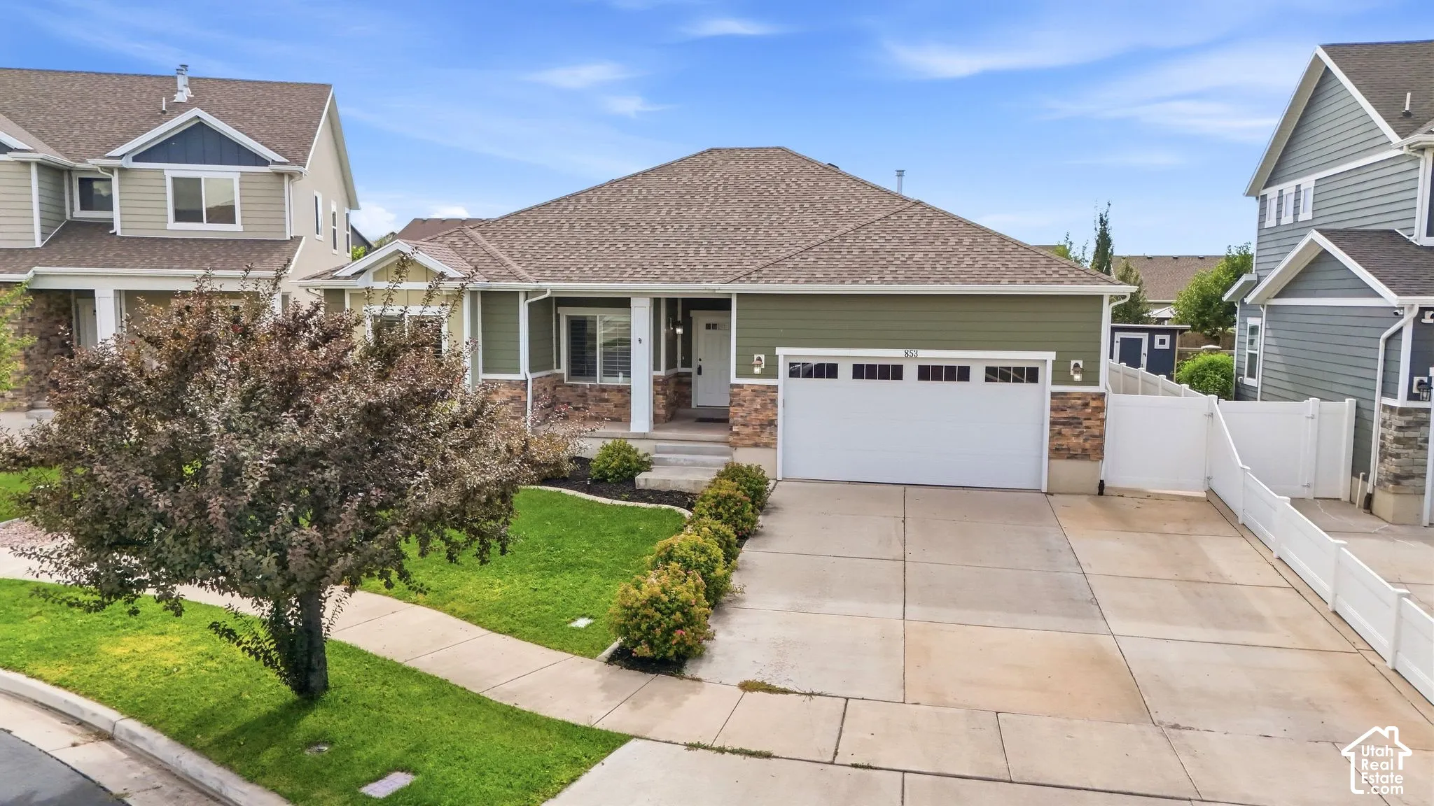 Single-story residence featuring a two-car garage, brick and siding exterior, front lawn, and concrete driveway