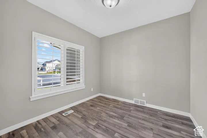 Wood-finish flooring, light grey wall paint, and white trim