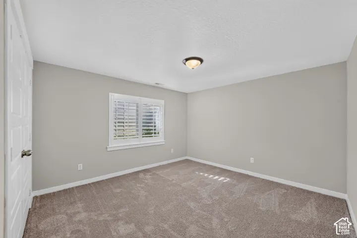 Neutral-toned wall paint with textured carpeting