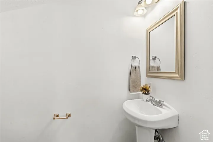 A half bath is attached to the large mudroom-laundry room.