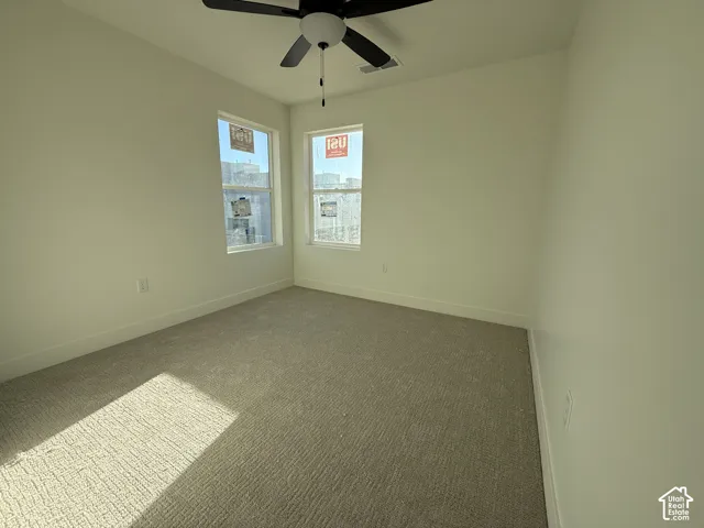 Recessed lighting, ceiling fan, and light-colored carpeting