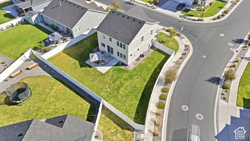Corner lot position, rear concrete patio, private fenced yard, manicured lawn, and established landscaping