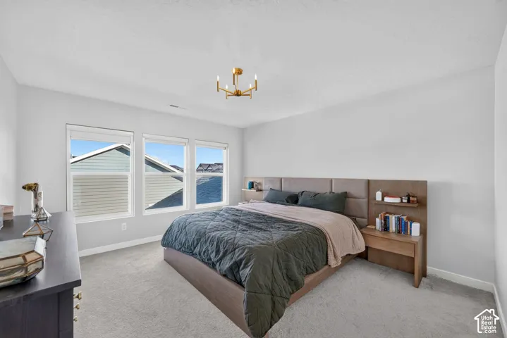 Primary bedroom upstairs featuring a walk in closet, primary bathroom and complete blackout shades