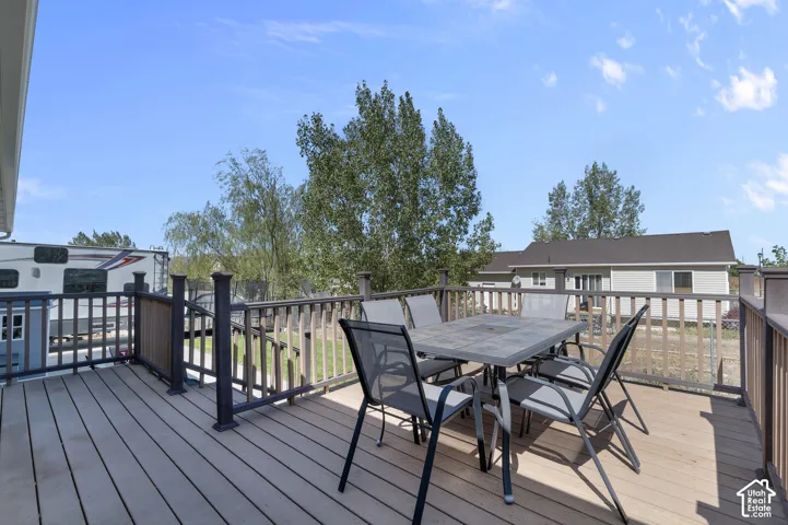 Spacious outdoor deck with railings and a privacy gate