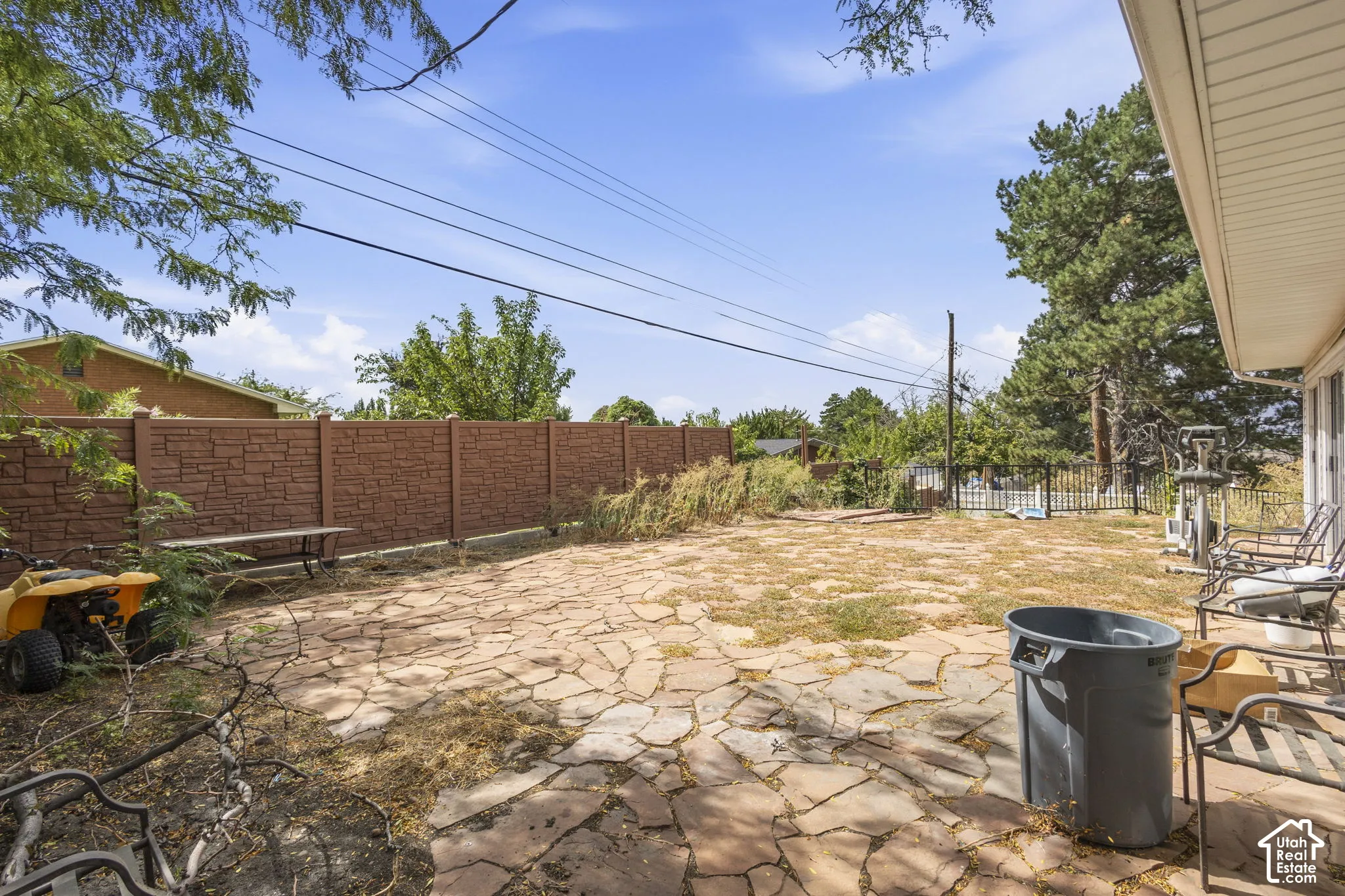 Expansive rear yard featuring natural stone patio