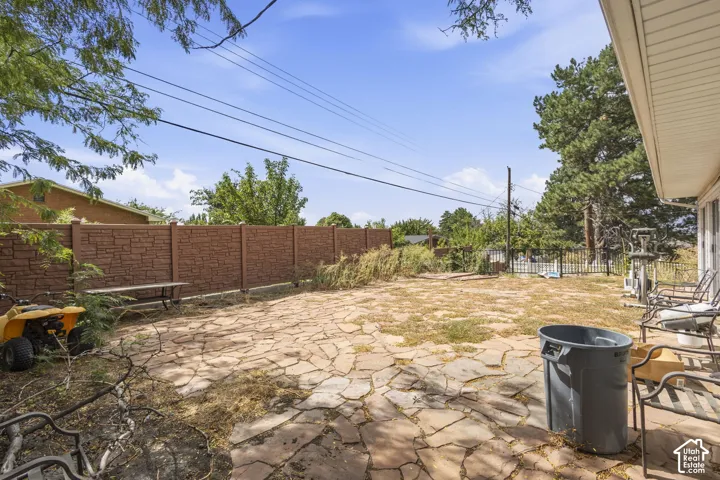 Expansive rear yard featuring natural stone patio
