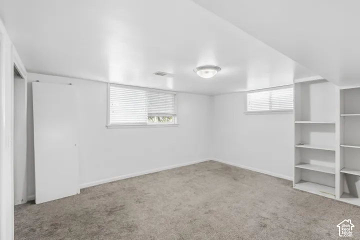 Room 4 located in the basement with carpet flooring