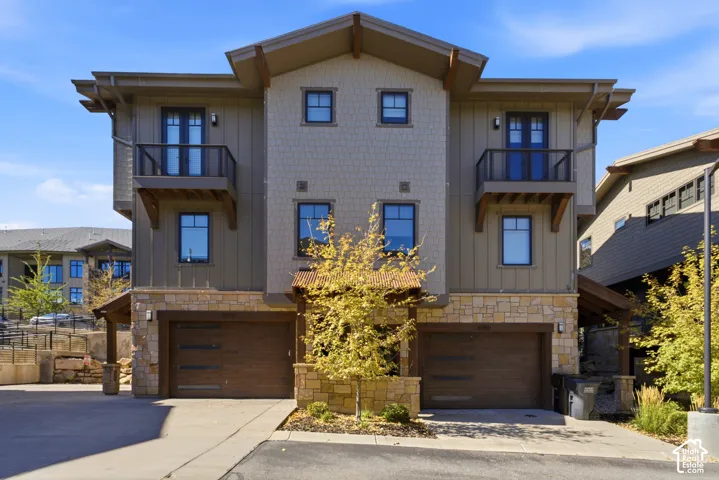 Multi-level exterior featuring stone accents, board and batten siding, shake siding, and individual balconies