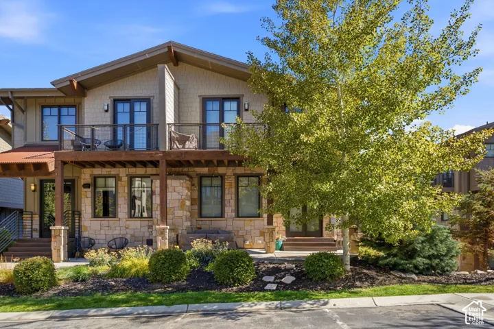 Two-story facade with stone and shingle siding