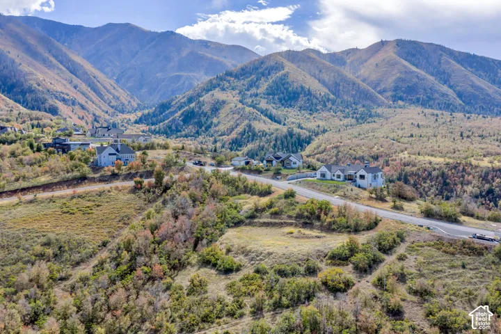 Mountainous landscape with scattered residential properties and paved roadways