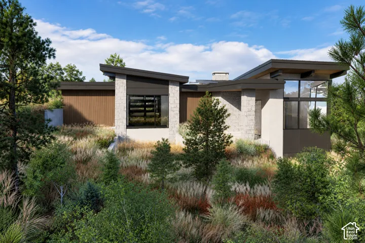 Modern architectural design featuring varied rooflines, stone and wood-look siding, and expansive multi-pane windows