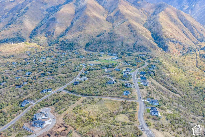 Mountainous terrain surrounding a residential area with established roads and properties