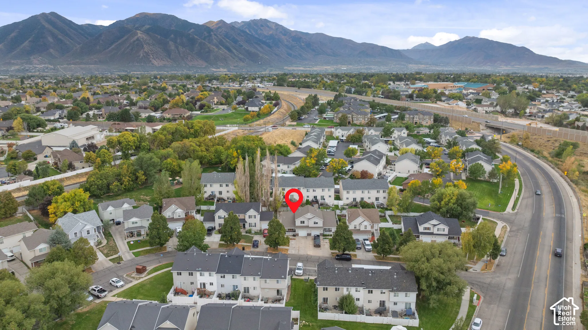 Neighborhood setting with mountainous backdrop, established residential street, and nearby highway access