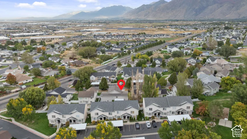 Aerial perspective showcasing a residential community with distant mountain ranges