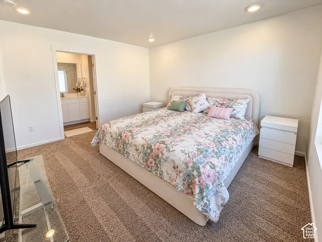 Recessed ceiling lighting, light neutral wall paint, and brown carpeting