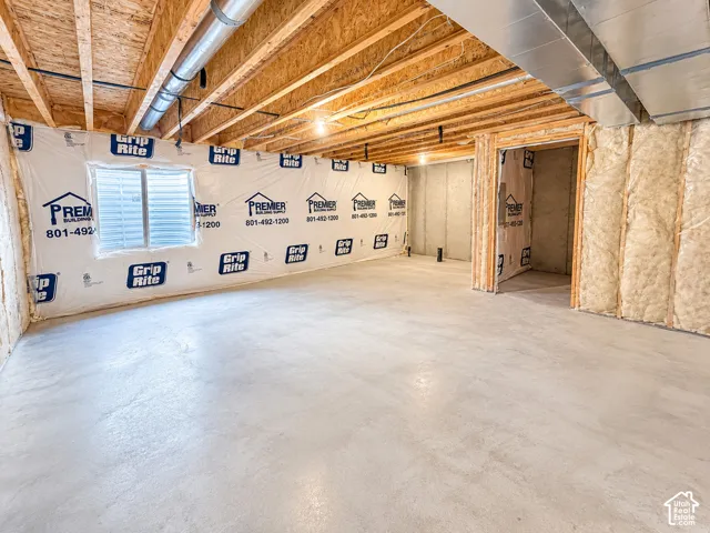 Unfinished space with exposed ceiling joists and concrete flooring