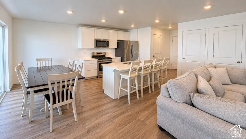 Open-concept living space with wood-finish flooring