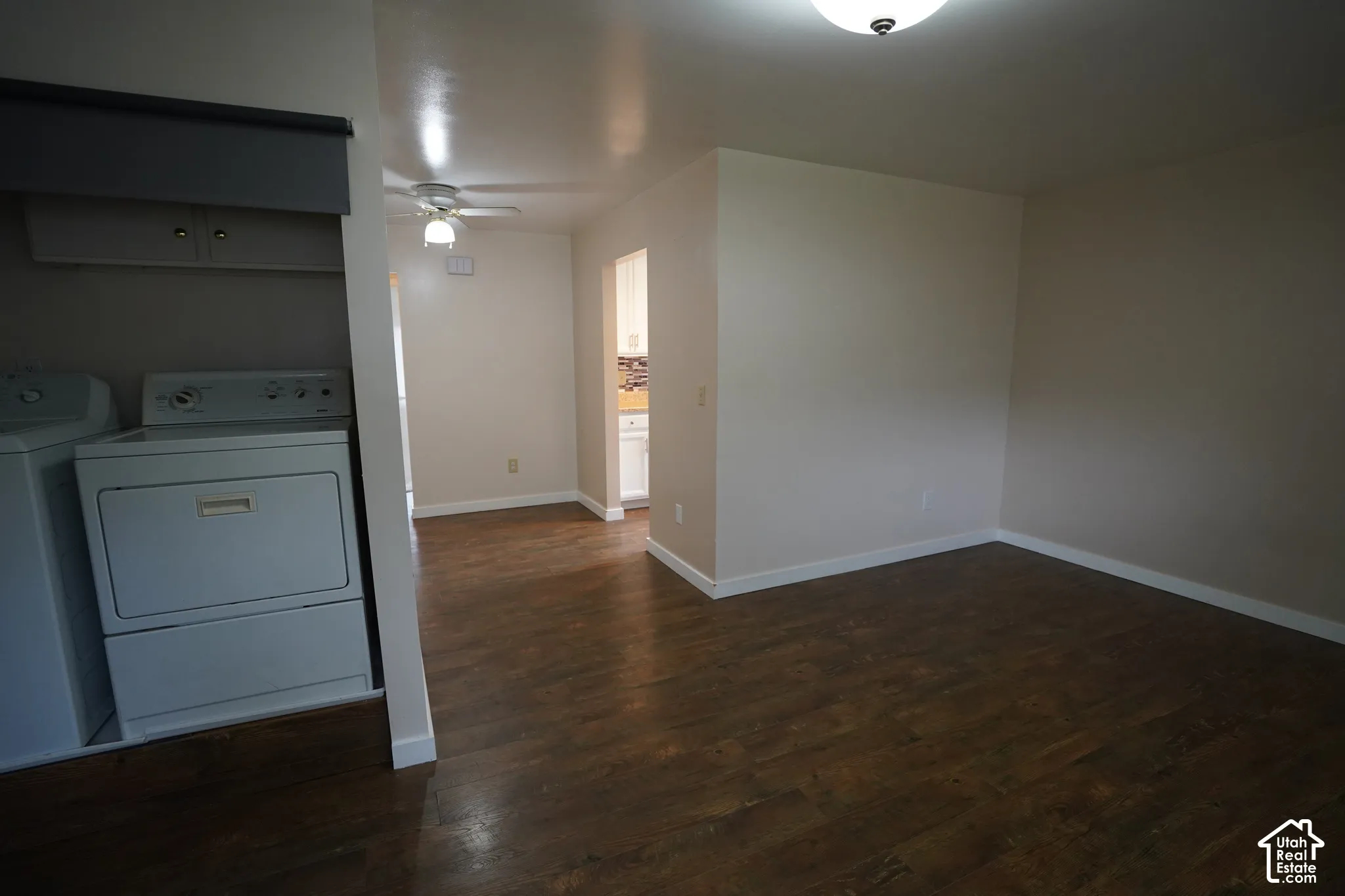 Wood-finish flooring throughout, neutral painted walls, and white trim
