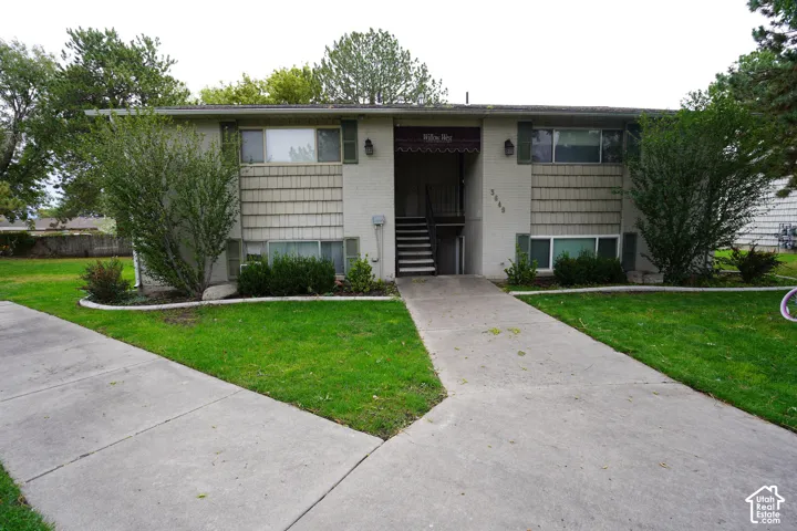 Two-story exterior with light-colored siding and a covered entry