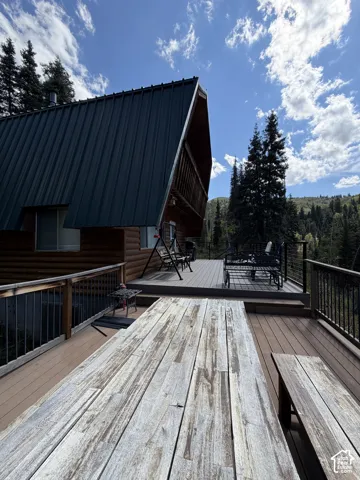 Expansive multi-level wood-finish deck with metal railings