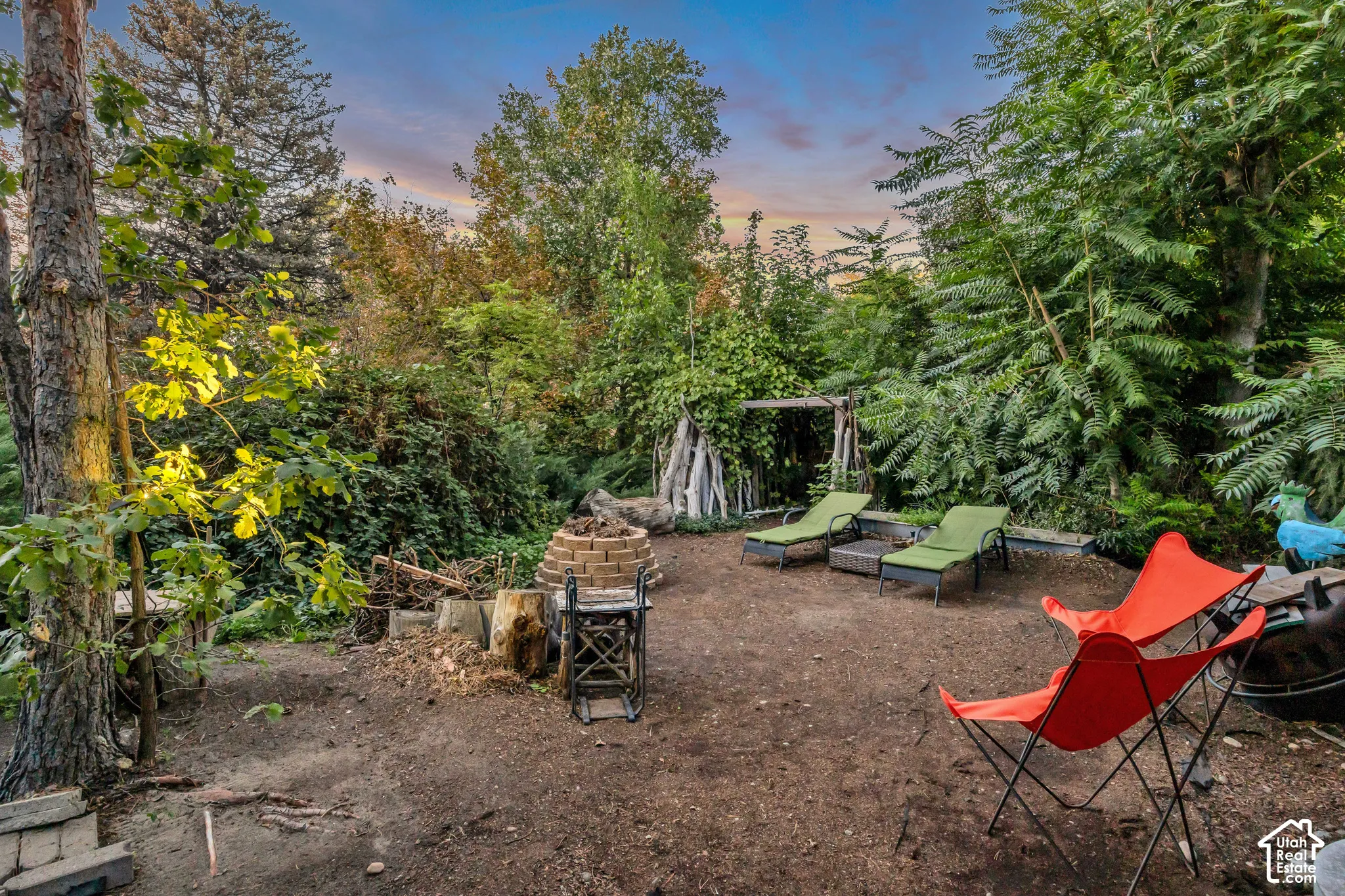 Outdoor patio area with a stone-lined fire pit