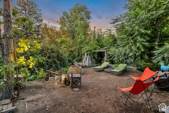 Outdoor patio area with a stone-lined fire pit