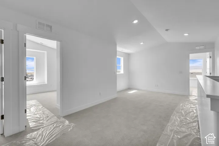 Vaulted media or loft area with mountain views.