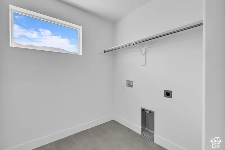 Generous laundry room with a window and mountain view.