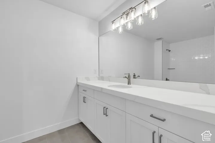 Large secondary bathroom with beautiful quartz countertops with a thick reveal.  Matte black upgraded hardware and fixtures, and tub and shower with tile surround.