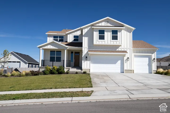 Our Bingham floorplan done in the farmhouse finish, with large covered porch, beautiful front landscaping and three car garage on a .50 acre lot!