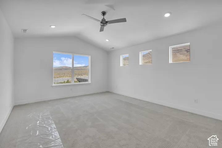 Vaulted primary bedroom with lots of windows and mountain views!