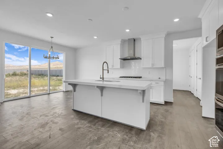 Spacious kitchen featuring a large island, upgraded gourmet stainless steel appliances including double ovens and gas cooktop. The three panel slider in the dining room opens to a deck and the generous backyard of this half acre lot!