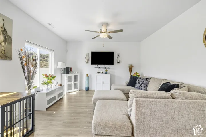 Vaulted ceilings, wood-finish flooring, and a large window provide ample natural light