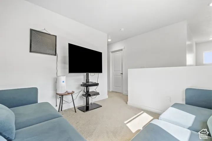 Carpeted flooring, white walls, recessed lighting, and a contemporary interior door with black hardware