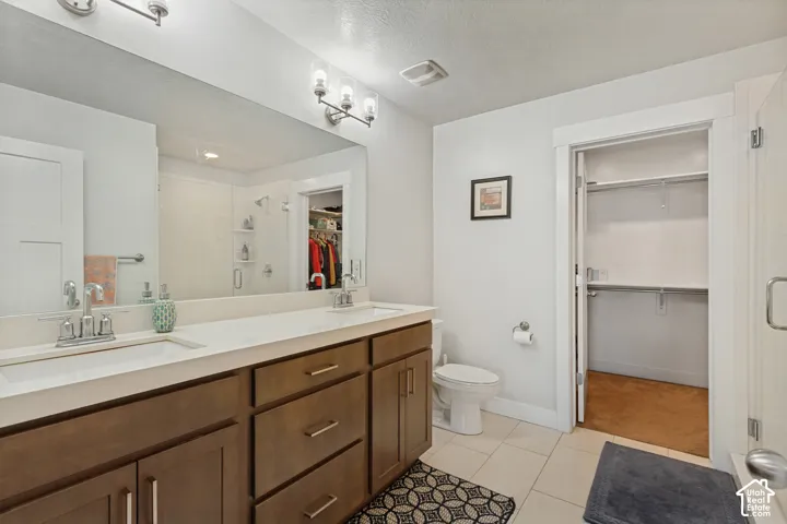 Dual vanity with a white countertop and wood-finish cabinetry