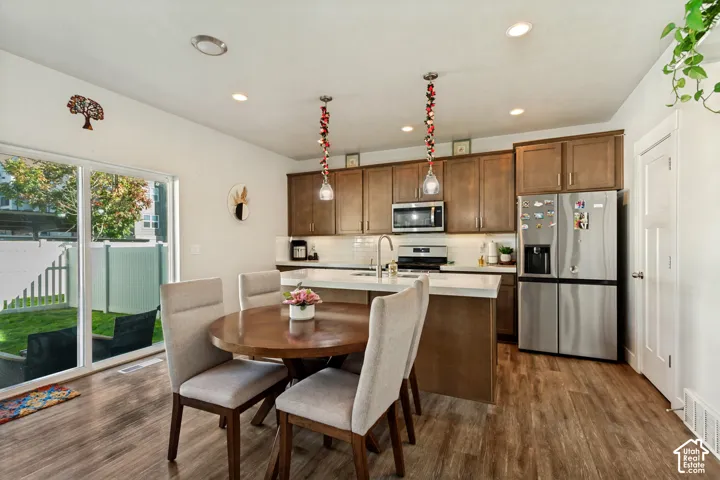 Kitchen featuring wood-finish flooring, recessed lighting, and stainless steel appliances