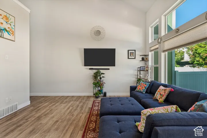 Vaulted ceilings, wood-finish flooring, and expansive windows