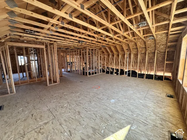 Open framing with exposed rafters and plywood subflooring