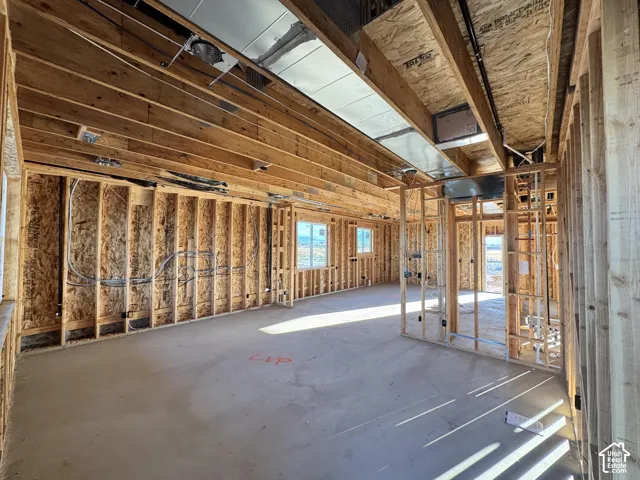 Framed interior with multiple window openings and visible overhead ductwork